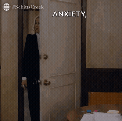 Woman In Suit And Tie In Front Of Anxiety Door GIF
