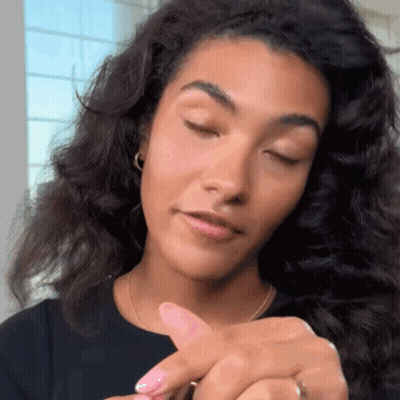 Woman In Suit And Tie Looking At Camera GIF