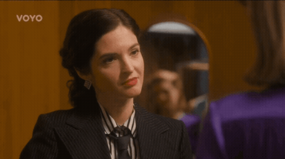 Woman In Suit And Tie Looking In Mirror Voyo GIF
