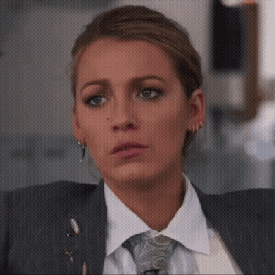 Woman In Suit And Tie Looks Serious GIF