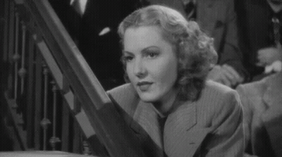 Woman In Suit And Tie On Staircase GIF