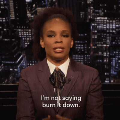 Woman In Suit And Tie Saying I'm Not Saying Burn It Down GIF