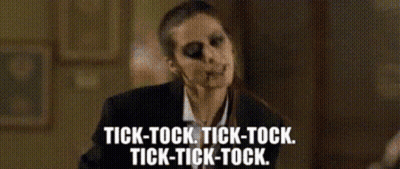 Woman In Suit And Tie Saying Tick-Tock Tick-Tock Tick-Tock GIF