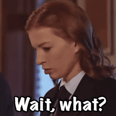 Woman In Suit And Tie Saying Wait What GIF