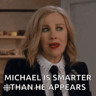 Woman In Suit And Tie Says Michael Is Smarter Than He Appears GIF