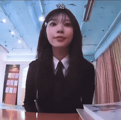 Woman In Suit And Tie Sitting At Table GIF