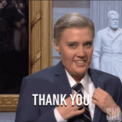 Woman In Suit And Tie Smiling Thank You GIF