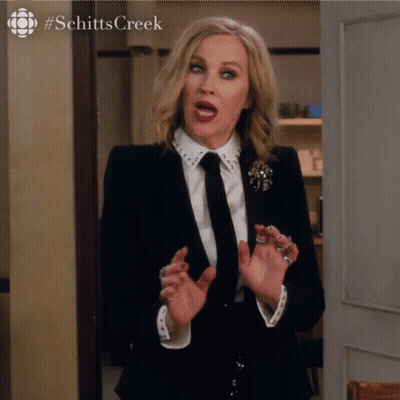 Woman in Suit and Tie With Schitts Creek