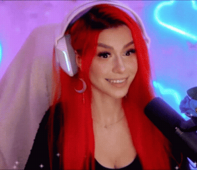Woman In Suit Clapping In Front Of Purple Wall GIF