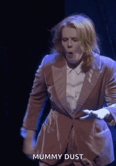 Woman In Suit Dancing Mummy Dust GIF