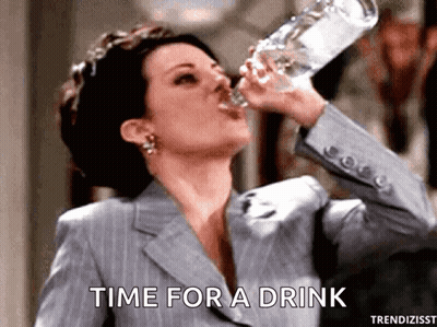 Woman In Suit Drinking Bottle Saying Time For A Drink GIF