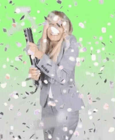 Woman In Suit Holding Cannon With Confetti GIF