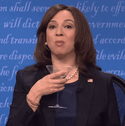 Woman In Suit Holding Martini Glass Saying Likely To Effect GIF