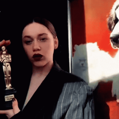Woman In Suit Holding Oscar And Dog Photo GIF