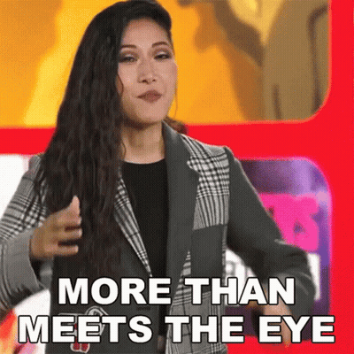 Woman In Suit In Front Of Red Sign More Than Meets The Eye GIF