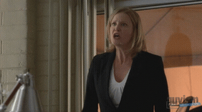 Woman In Suit In Front Of Window With Guyson Watermark GIF