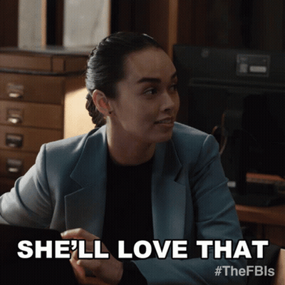 Woman In Suit Saying She'll Love That On A Screen GIF