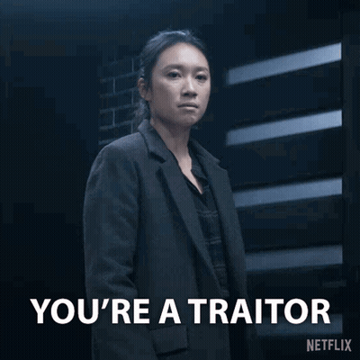 Woman In Suit Says You're A Traitor GIF
