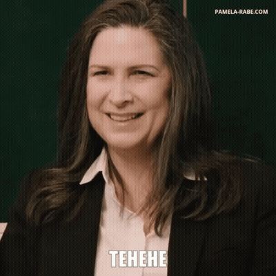 Woman In Suit Smiling In Front Of Blackboard GIF
