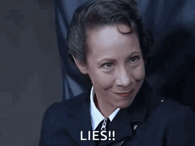 Woman In Suit Smiling Says Lies GIF