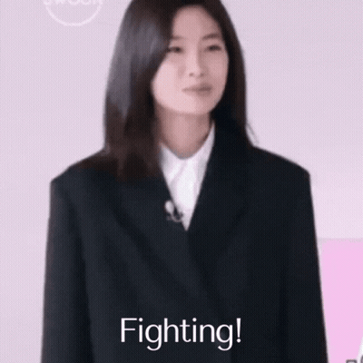 Woman in Suit Smiling With Fist Up Saying Fighting