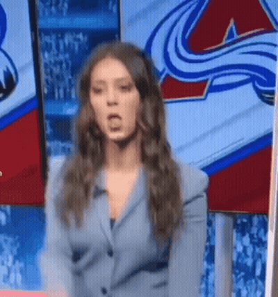 Woman In Suit Standing Before Hockey Logo GIF