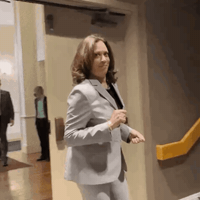Woman In Suit Standing By Yellow Railing GIF