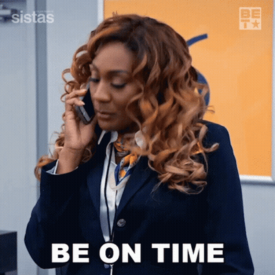Woman In Suit Talking On Cell Phone Saying Be On Time GIF
