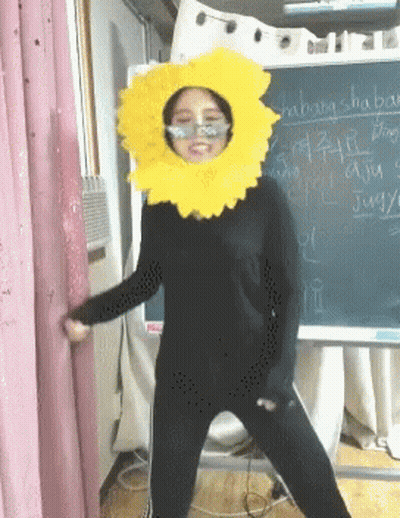 Woman In Sunflower Costume With Shabang Shaping Chalkboard GIF