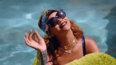Woman In Sunglasses And Bandana Laying In Pool GIF