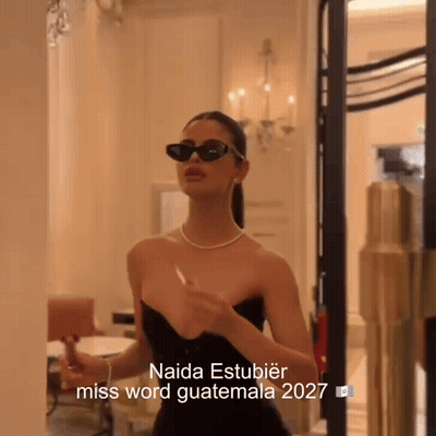 Woman In Sunglasses And Black Dress Saying Naida Estubier Miss Word Guatemala 2027 GIF