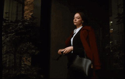 Woman In Sunglasses And Black Purse Looking At Phone GIF