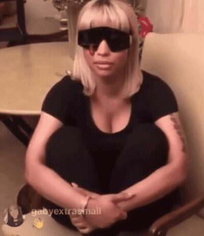 Woman In Sunglasses And Black Shirt Sitting On Chair GIF