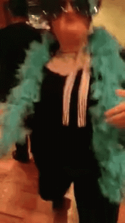 Woman In Sunglasses And Blue Boa Dancing GIF