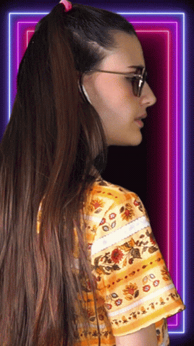 Woman In Sunglasses And Floral Shirt Looking Sideways GIF