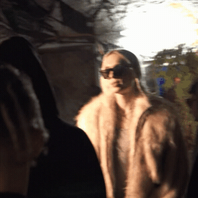 Woman In Sunglasses And Fur Coat In Dark GIF