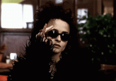 Woman In Sunglasses And Fur Coat Making Peace Sign GIF