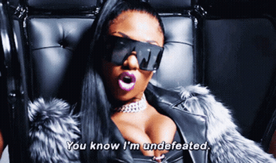 Woman In Sunglasses And Fur Coat Saying You Know I'm Undefeated GIF