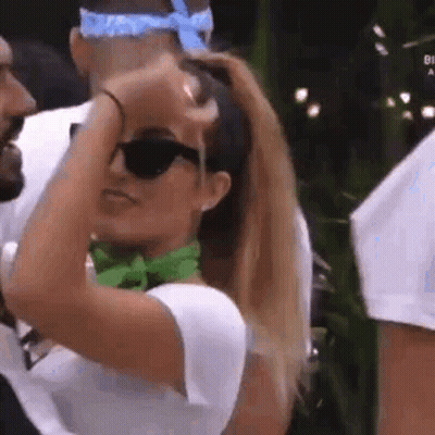 Woman In Sunglasses And Green Scarf Beside Man GIF