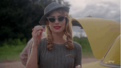 Woman In Sunglasses And Hat Next To Yellow Car GIF