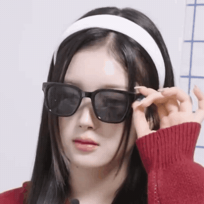 Woman In Sunglasses And Headband Making A Face GIF