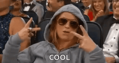 Woman In Sunglasses And Hoodie Making Peace Sign In Crowd GIF