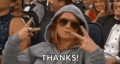 Woman In Sunglasses And Hoodie Sitting In Crowd GIF