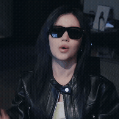 Woman In Sunglasses And Leather Jacket Making Funny Face GIF