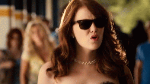 Woman in Sunglasses and Necklace Making a Face
