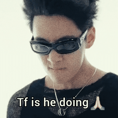 Woman In Sunglasses And Necklace Saying TF Is He Doing GIF