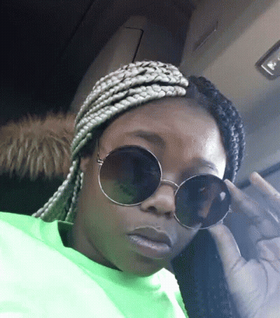 Woman In Sunglasses And Neon Green Shirt Giving Middle Finger GIF