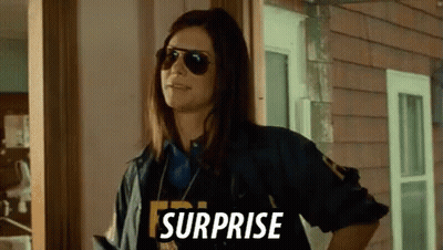 Woman In Sunglasses And Police Uniform Saying Surprise GIF