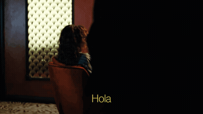 Woman In Sunglasses And Red Chair Saying Hola GIF