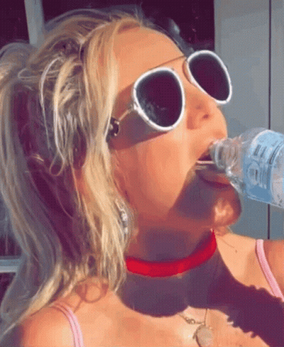 Woman In Sunglasses And Red Choker Drinking Water GIF